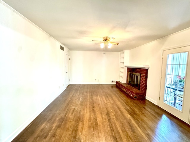 unfurnished living room featuring visible vents, a ceiling fan, wood finished floors, and a fireplace