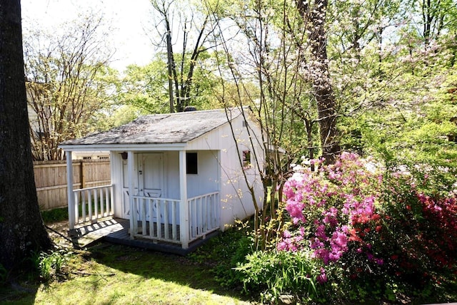 view of shed featuring fence