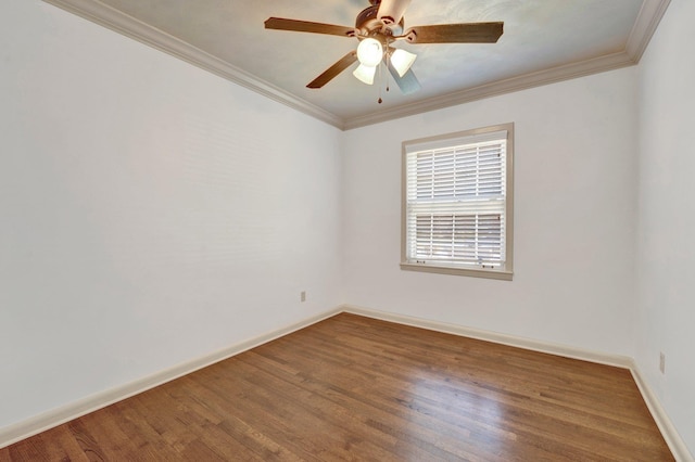 unfurnished room featuring a ceiling fan, wood finished floors, baseboards, and ornamental molding