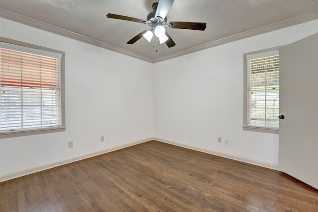 spare room with crown molding, plenty of natural light, and wood finished floors