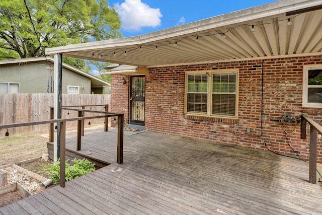 wooden terrace featuring fence