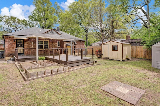 back of house featuring fence private yard, an outdoor structure, a shed, a lawn, and a vegetable garden