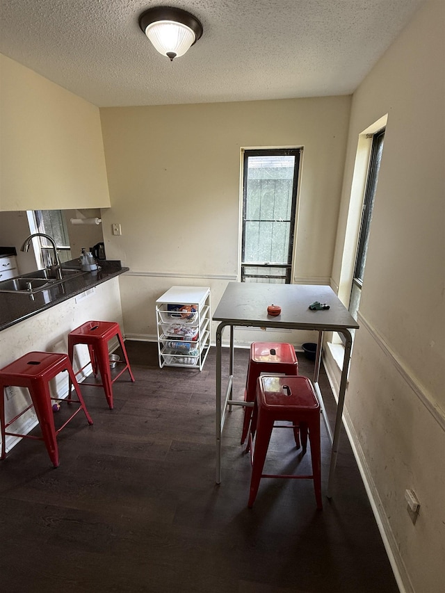 3287 Leschallas Dr, Memphis, TN 38128 - dining space with a textured ceiling, wood finished floors, and baseboards