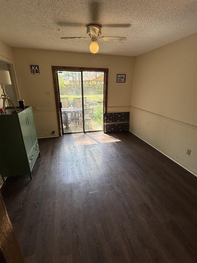 3287 Leschallas Dr, Memphis, TN 38128 - unfurnished dining area featuring a textured ceiling, a ceiling fan, baseboards, and dark wood finished floors