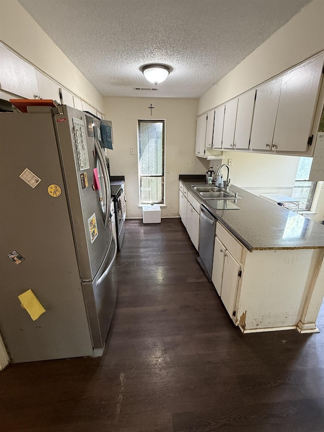 3287 Leschallas Dr, Memphis, TN 38128 - kitchen with a textured ceiling, white cabinetry, dark wood finished floors, stainless steel appliances, and a sink