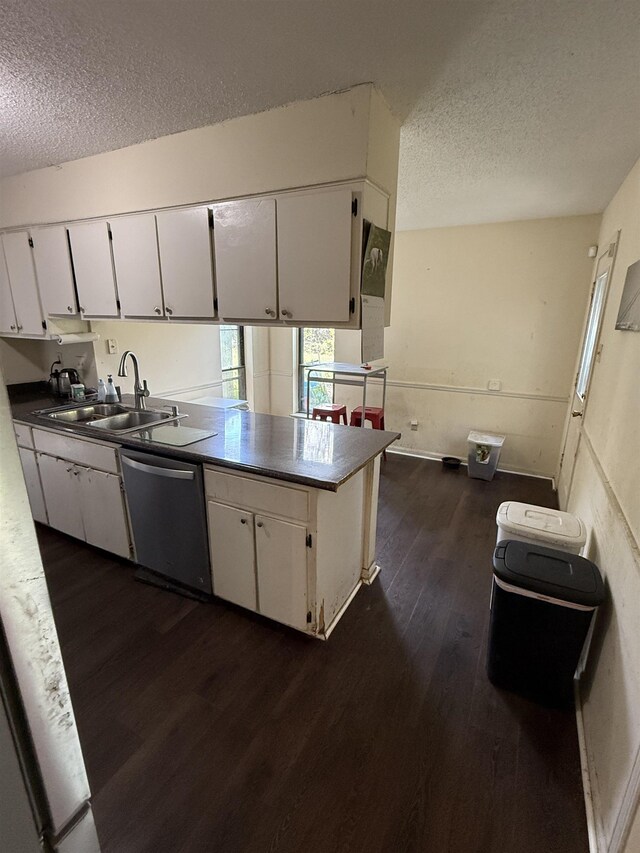 3287 Leschallas Dr, Memphis, TN 38128 - kitchen with a textured ceiling, white cabinetry, dishwasher, a sink, and dark wood-style flooring