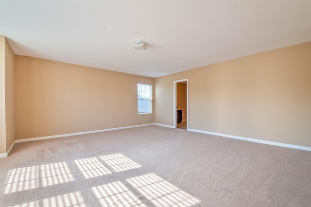 10317 Cottage Oaks Dr, Memphis, TN 38016 - empty room featuring baseboards and light colored carpet