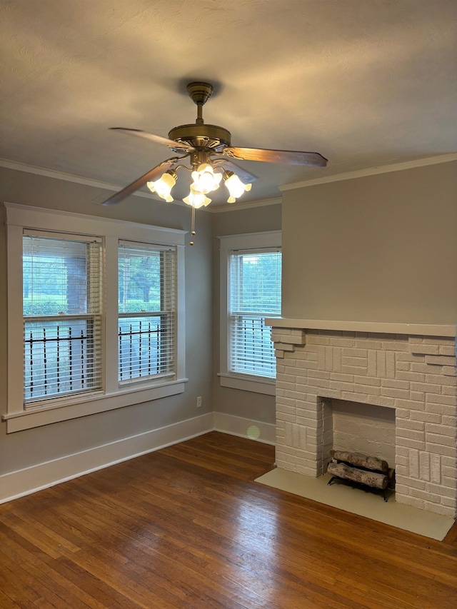 unfurnished living room with ornamental molding, baseboards, ceiling fan, and dark wood-style floors