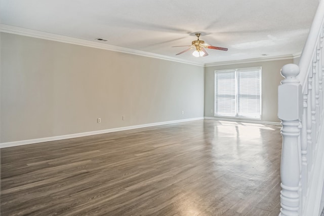 empty room featuring ornamental molding, baseboards, a ceiling fan, and wood finished floors