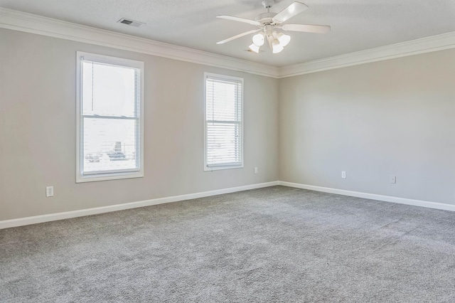 spare room with baseboards, ornamental molding, a ceiling fan, and carpet floors