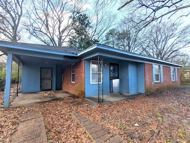 1337 Haywood Ave, Memphis, TN 38127 - view of front of house with brick siding, covered porch, and an attached carport