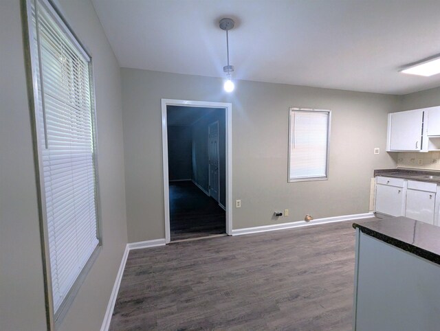 1337 Haywood Ave, Memphis, TN 38127 - unfurnished dining area featuring dark wood-type flooring and baseboards