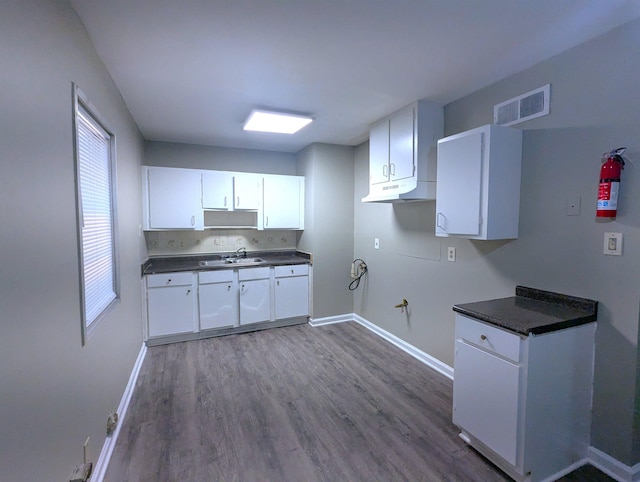 1337 Haywood Ave, Memphis, TN 38127 - kitchen with dark countertops, baseboards, and dark wood finished floors