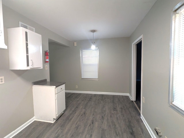 1337 Haywood Ave, Memphis, TN 38127 - unfurnished dining area with dark wood-style floors, plenty of natural light, and baseboards