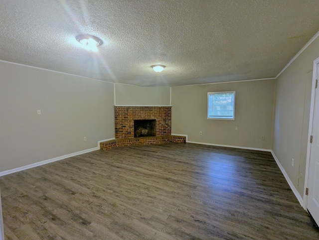 1337 Haywood Ave, Memphis, TN 38127 - unfurnished living room with a textured ceiling, wood finished floors, a brick fireplace, baseboards, and ornamental molding
