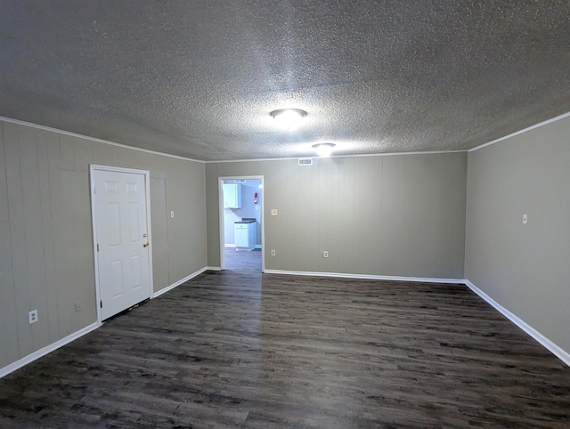 1337 Haywood Ave, Memphis, TN 38127 - unfurnished room with dark wood-type flooring, baseboards, a textured ceiling, and ornamental molding