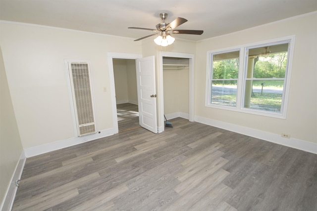 899 Craft Rd, Memphis, TN 38116 - unfurnished bedroom featuring baseboards, ornamental molding, a heating unit, and wood finished floors