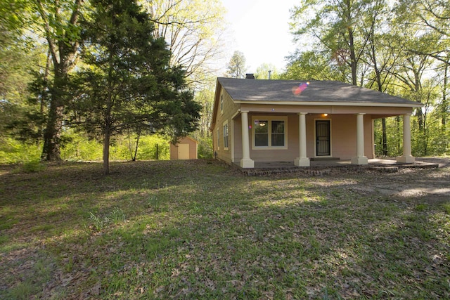 899 Craft Rd, Memphis, TN 38116 - exterior space featuring an outbuilding, a storage shed, a porch, a front yard, and a chimney