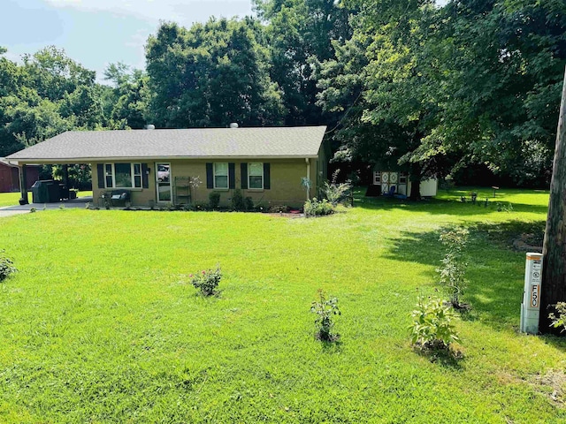 ranch-style home with a front lawn and an attached carport