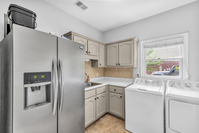 laundry room featuring a sink, visible vents, laundry area, and washing machine and dryer