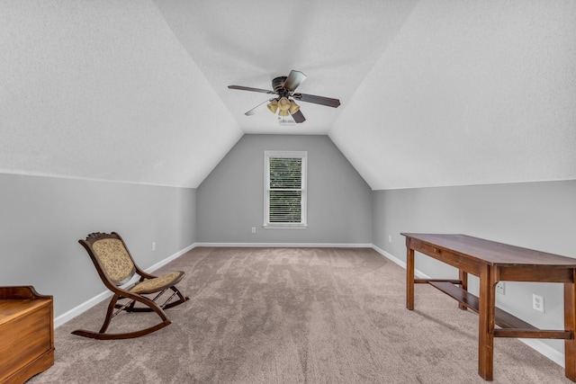 unfurnished room featuring carpet, a ceiling fan, vaulted ceiling, and baseboards