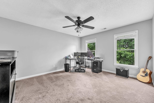 office with baseboards, visible vents, a ceiling fan, and carpet