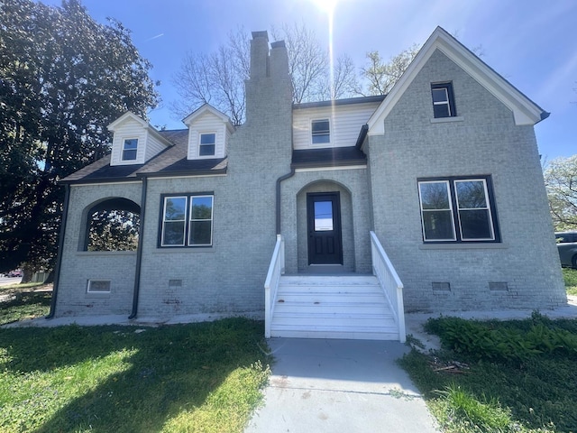 137 W S St, Dyer, TN 38330 - view of front of property with crawl space, a chimney, a front lawn, and brick siding