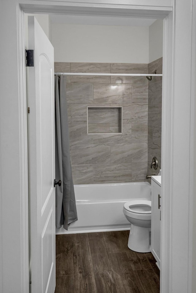 137 W S St, Dyer, TN 38330 - bathroom featuring shower / bathtub combination with curtain, vanity, toilet, and wood finished floors