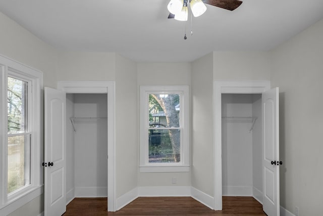 137 W S St, Dyer, TN 38330 - unfurnished bedroom with dark wood-type flooring, baseboards, and multiple windows
