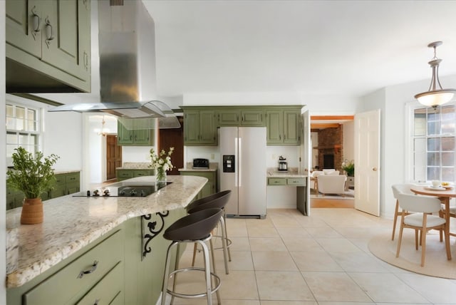 63 Shady Glen Rd, Memphis, TN 38120 - kitchen with white refrigerator with ice dispenser, green cabinetry, black electric cooktop, ventilation hood, and plenty of natural light