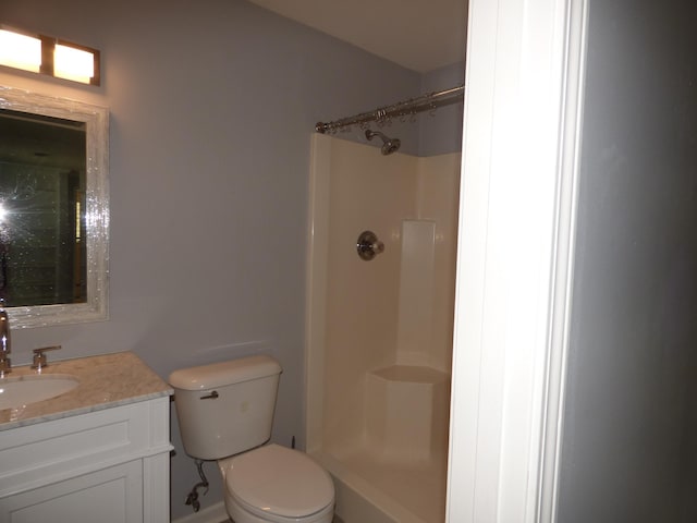 full bath featuring toilet, vanity, and a shower