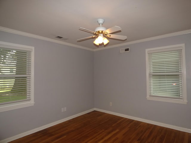 spare room with dark wood-type flooring, baseboards, a ceiling fan, and visible vents