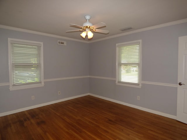 unfurnished room featuring wood finished floors, baseboards, and visible vents