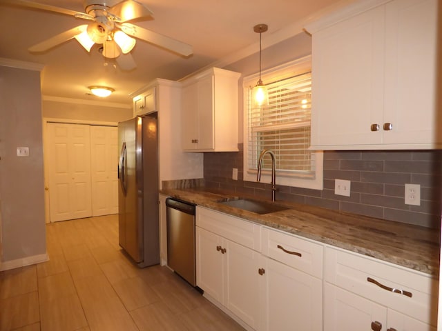 kitchen with crown molding, appliances with stainless steel finishes, decorative backsplash, and a sink