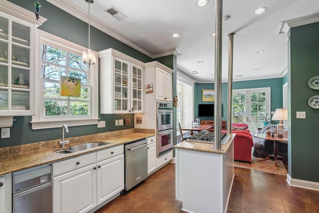 kitchen featuring stainless steel appliances, concrete floors, a sink, and ornamental molding