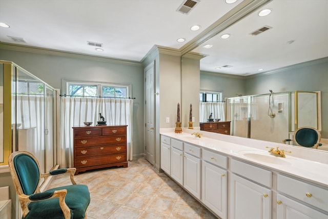 bathroom featuring a sink, visible vents, a shower stall, and ornamental molding