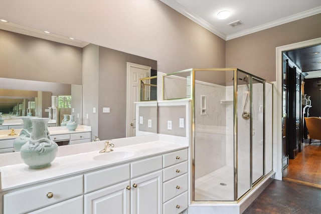 bathroom featuring visible vents, crown molding, vanity, wood finished floors, and a stall shower
