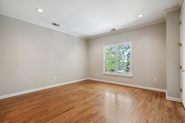 spare room with crown molding, visible vents, baseboards, and recessed lighting