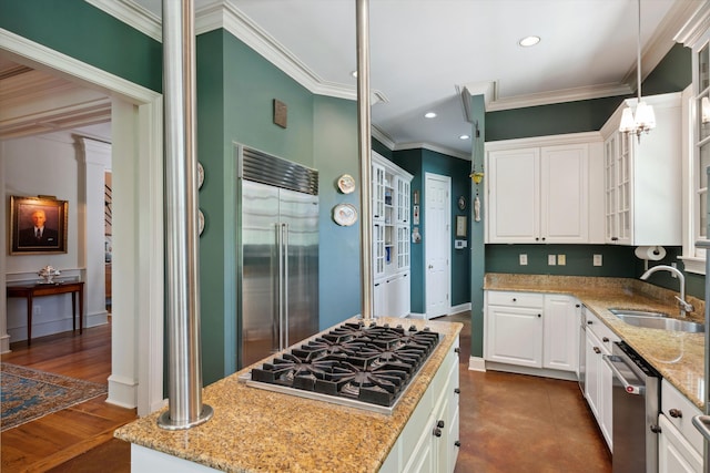 kitchen with stainless steel appliances, light stone countertops, a sink, and ornamental molding