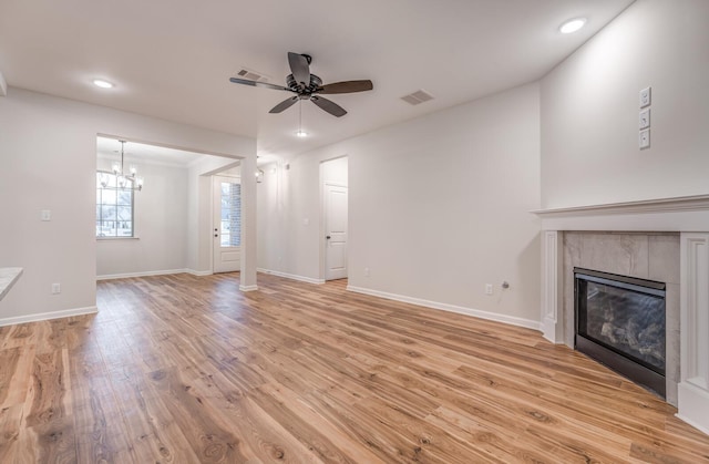 185 Valleyview Ln, Oakland, TN 38060 - unfurnished living room featuring visible vents, light wood finished floors, a tile fireplace, and ceiling fan with notable chandelier