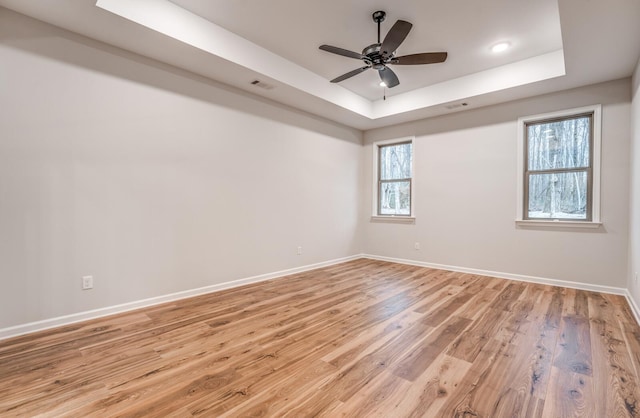 185 Valleyview Ln, Oakland, TN 38060 - empty room with baseboards, a ceiling fan, light wood-style floors, visible vents, and a raised ceiling