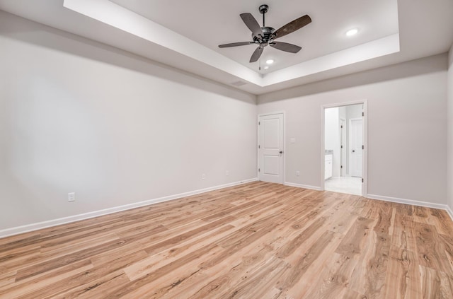 185 Valleyview Ln, Oakland, TN 38060 - unfurnished room featuring a raised ceiling, ceiling fan, light wood finished floors, and baseboards