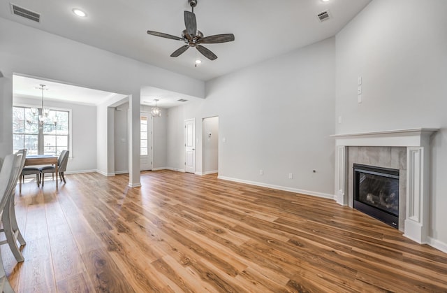 175 Valleyview Ln, Oakland, TN 38060 - unfurnished living room featuring light wood-style floors, a fireplace, visible vents, and ceiling fan with notable chandelier