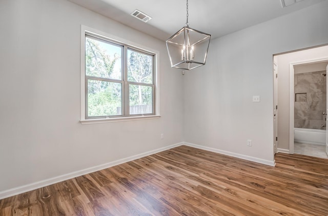 175 Valleyview Ln, Oakland, TN 38060 - unfurnished dining area with visible vents, baseboards, a chandelier, and wood finished floors