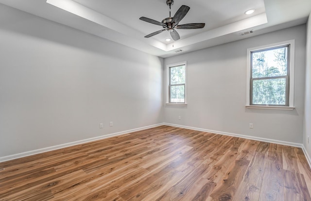 175 Valleyview Ln, Oakland, TN 38060 - unfurnished room with visible vents, baseboards, a raised ceiling, recessed lighting, and wood finished floors