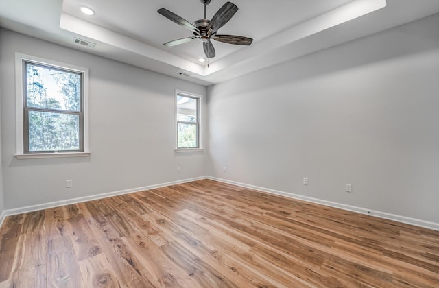 175 Valleyview Ln, Oakland, TN 38060 - empty room featuring visible vents, baseboards, a tray ceiling, and light wood-style floors