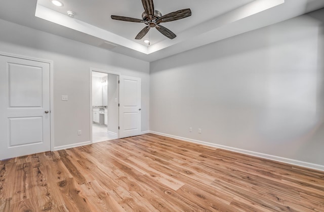 175 Valleyview Ln, Oakland, TN 38060 - unfurnished bedroom with ensuite bathroom, a tray ceiling, light wood-style flooring, recessed lighting, and baseboards