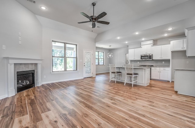 175 Valleyview Ln, Oakland, TN 38060 - kitchen featuring ceiling fan, light wood-type flooring, white cabinets, stainless steel microwave, and open floor plan