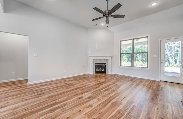 175 Valleyview Ln, Oakland, TN 38060 - unfurnished living room with baseboards, ceiling fan, recessed lighting, light wood finished floors, and a glass covered fireplace