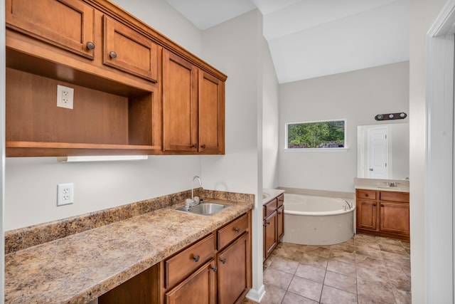 bathroom featuring a sink, two vanities, tile patterned flooring, and a bath